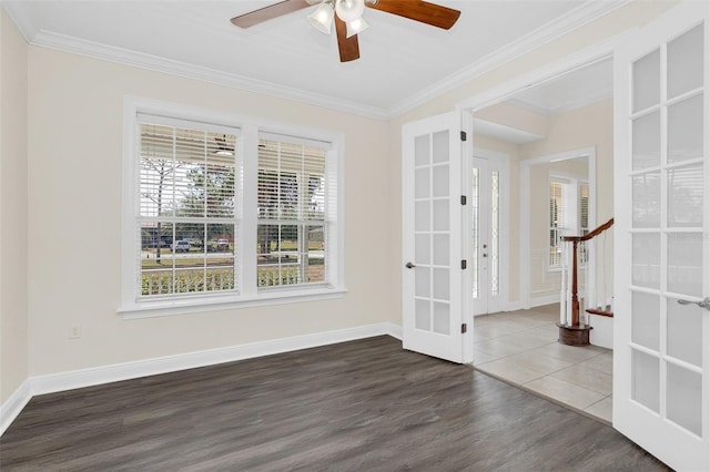 empty room featuring hardwood / wood-style floors, ceiling fan, crown molding, and french doors