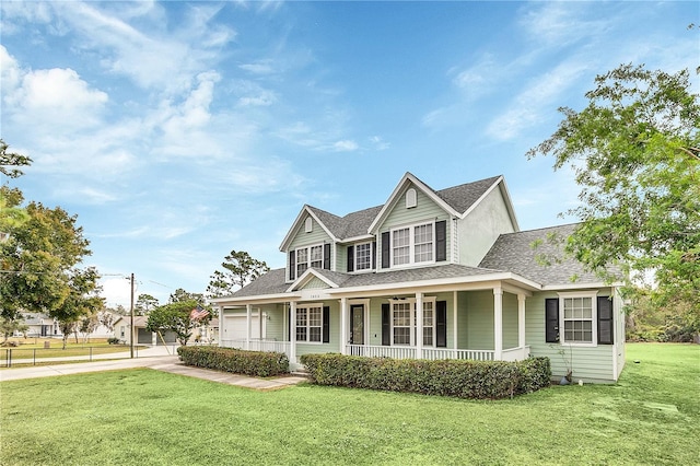 view of front facade featuring a front yard, a porch, and a garage