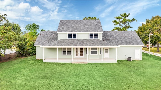 rear view of property with a lawn, cooling unit, a patio area, and french doors