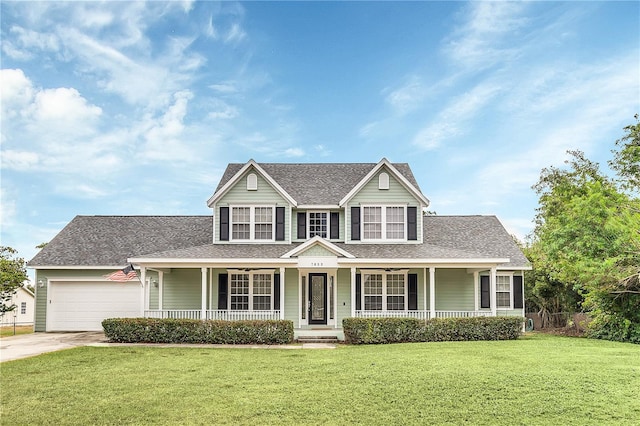 view of front of house featuring a front lawn, a porch, and a garage