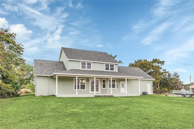 rear view of house featuring central AC unit, covered porch, and a yard