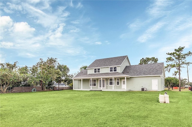 back of house with a lawn and cooling unit