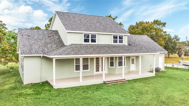 rear view of house featuring a yard, a patio, and central AC unit