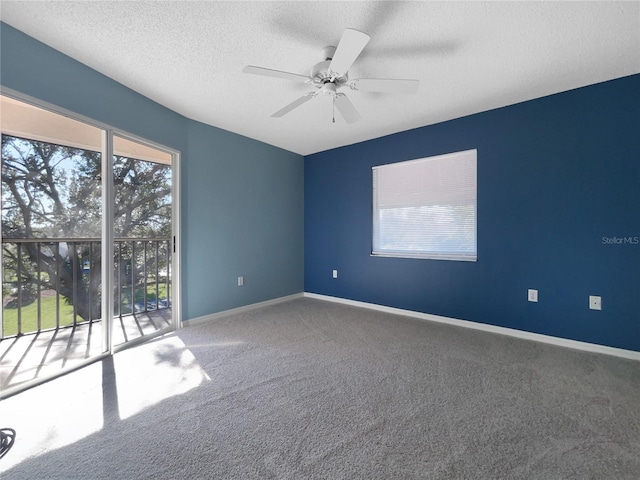 carpeted spare room with ceiling fan and a textured ceiling