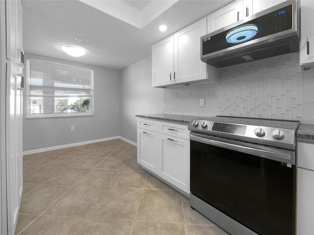 kitchen with backsplash, stainless steel appliances, and white cabinetry