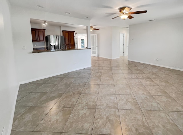 unfurnished living room with ceiling fan