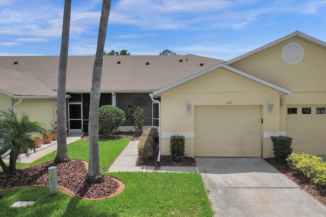 ranch-style home with a front yard and a garage