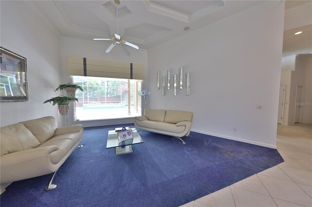 tiled living room featuring beam ceiling, ceiling fan, a high ceiling, coffered ceiling, and ornamental molding