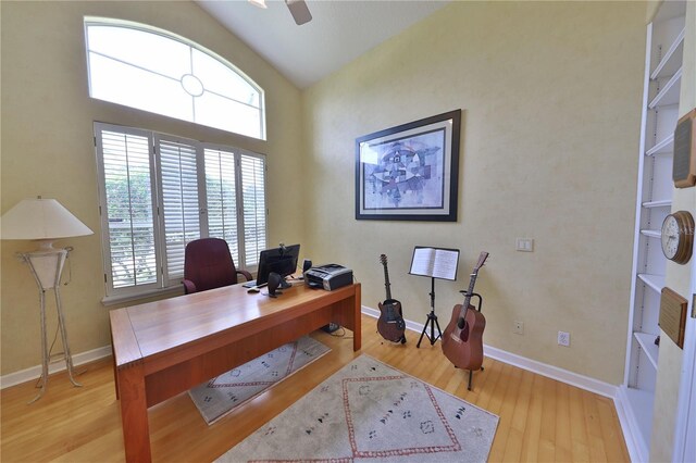 home office with light hardwood / wood-style floors, vaulted ceiling, and ceiling fan