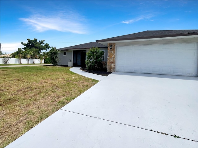 ranch-style home with a garage and a front yard