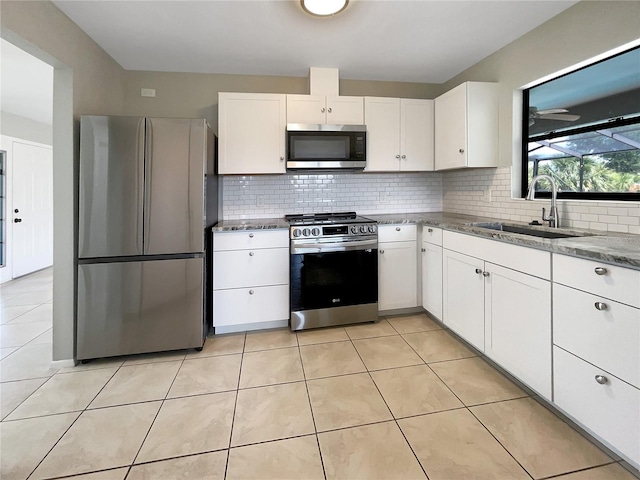 kitchen featuring sink, white cabinetry, stainless steel appliances, and tasteful backsplash