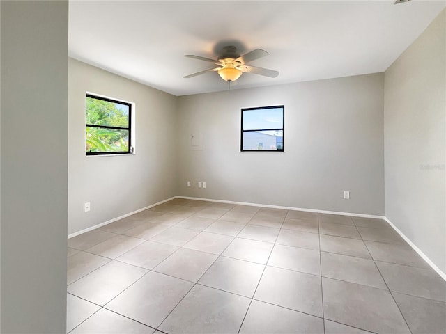 unfurnished room with light tile patterned floors and ceiling fan