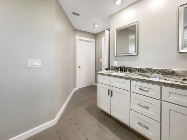 bathroom featuring tile patterned flooring and vanity