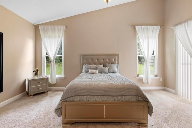 bedroom with light carpet and lofted ceiling