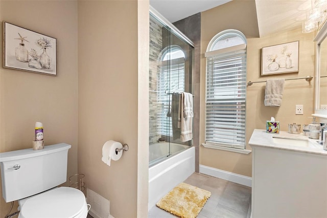 full bathroom featuring tile patterned floors, toilet, combined bath / shower with glass door, and vanity