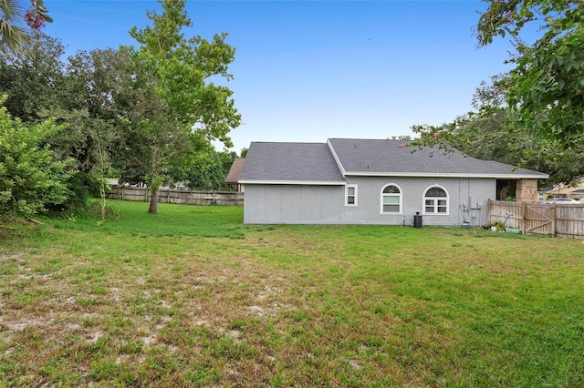 back of house featuring a yard