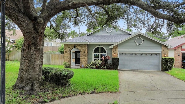 view of front facade featuring a front yard and a garage