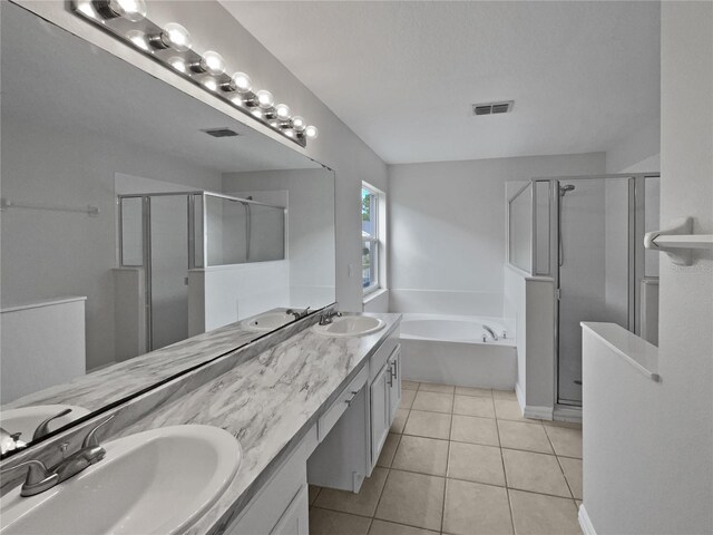 bathroom featuring tile patterned flooring, vanity, and plus walk in shower