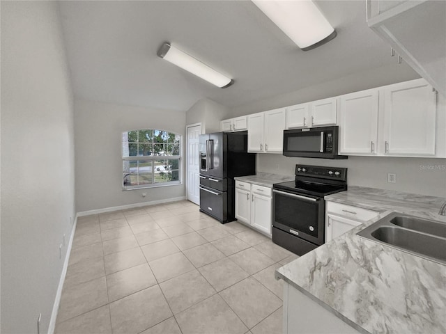 kitchen with white cabinetry, sink, lofted ceiling, light tile patterned flooring, and black appliances