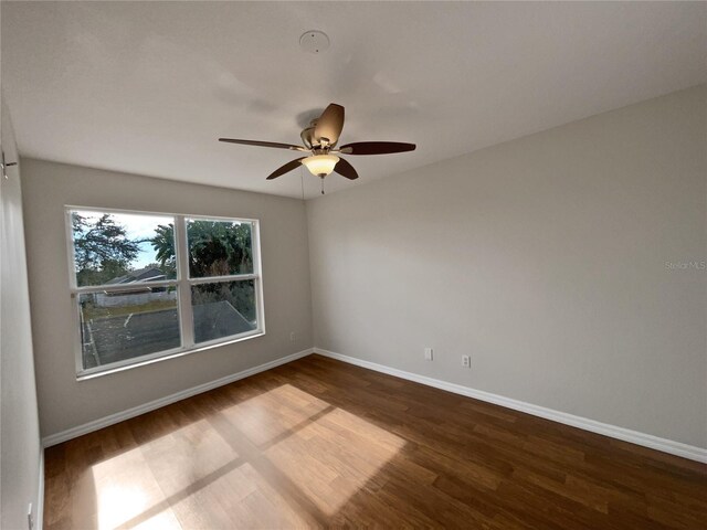 empty room with hardwood / wood-style flooring and ceiling fan