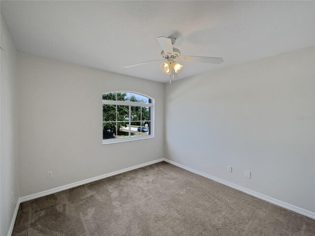 empty room with carpet flooring and ceiling fan