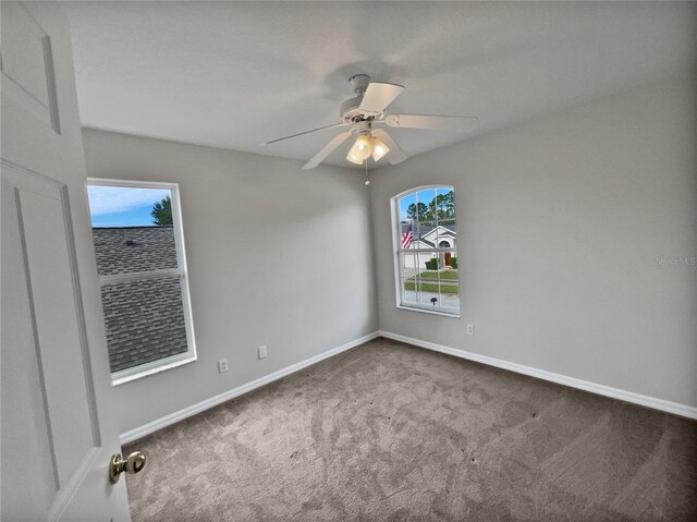 empty room featuring ceiling fan and carpet floors