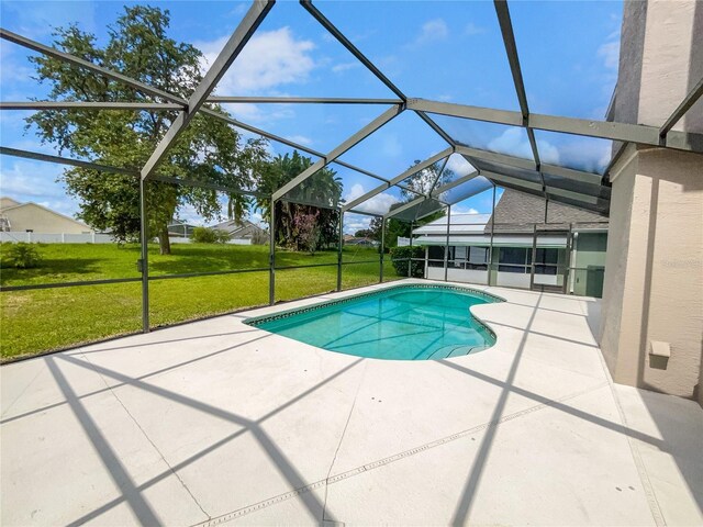 view of pool featuring a patio, a lanai, and a lawn