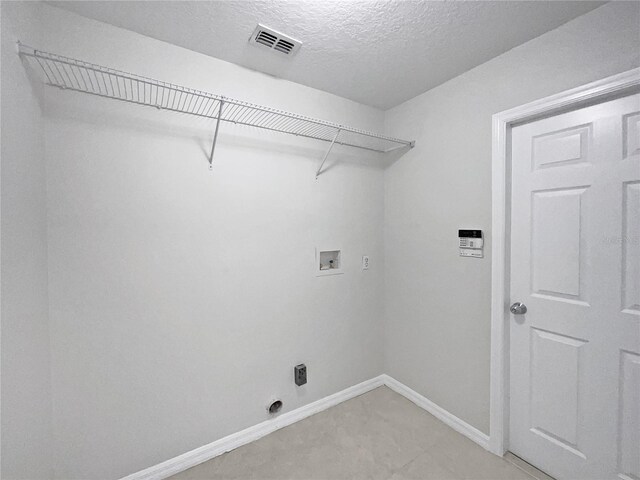 clothes washing area featuring washer hookup and a textured ceiling