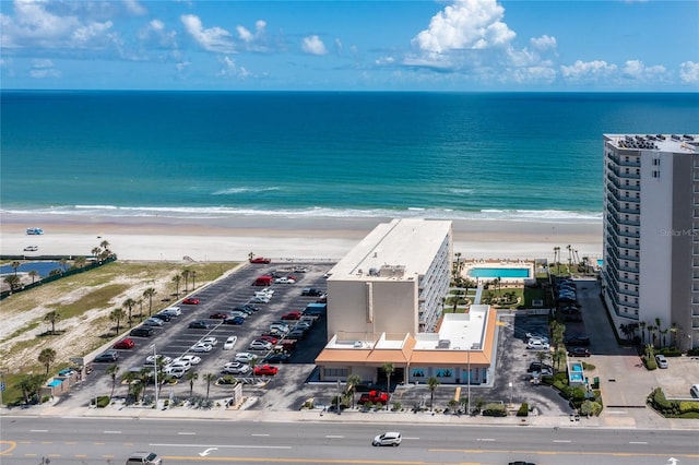 bird's eye view featuring a view of the beach and a water view