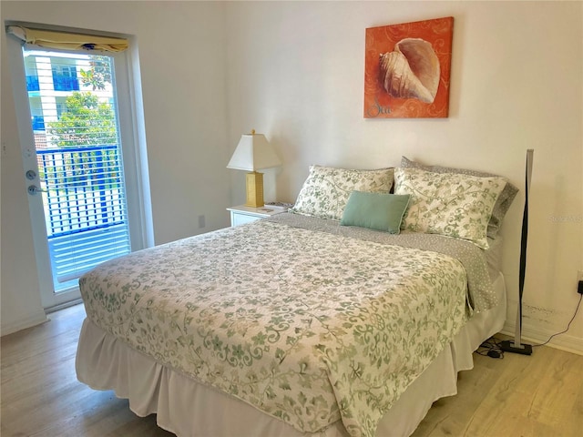 bedroom featuring hardwood / wood-style flooring and access to outside