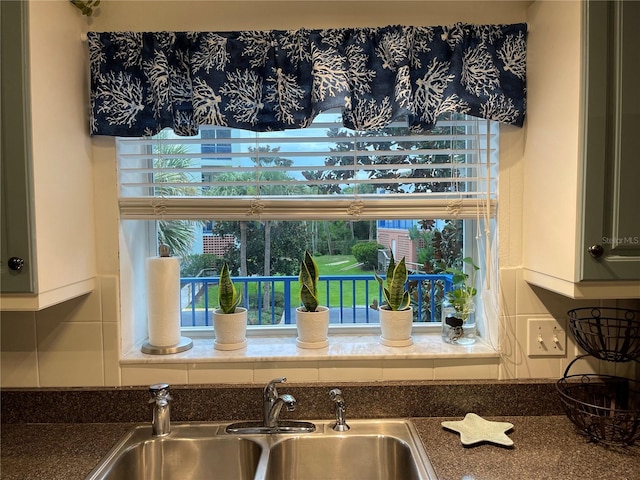 details featuring tasteful backsplash and sink