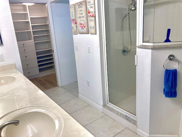 bathroom featuring an enclosed shower, vanity, and tile patterned flooring