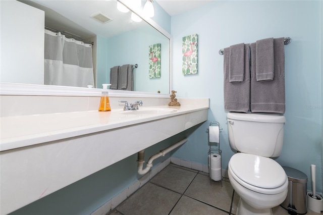 bathroom featuring tile patterned floors, vanity, and toilet