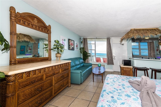 tiled bedroom with a textured ceiling