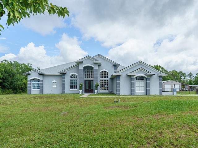 single story home featuring a front yard