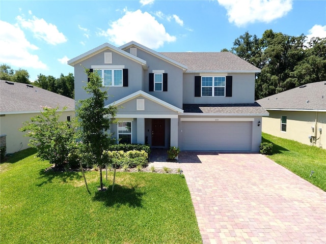 view of front of home with a garage and a front yard