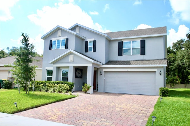 view of front of house with a front yard and a garage