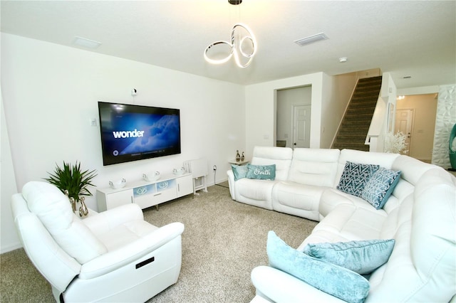 carpeted living room with a chandelier