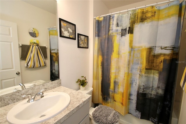 bathroom featuring vanity, a shower with shower curtain, and toilet