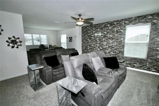 living room with carpet flooring, ceiling fan, and plenty of natural light