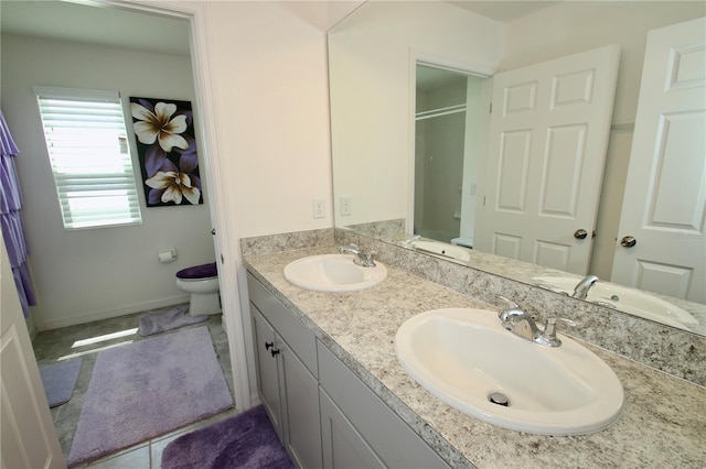 bathroom featuring a shower, vanity, and toilet