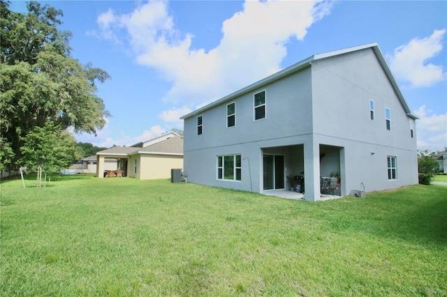 rear view of property featuring a yard