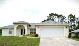 single story home with a front lawn and a garage