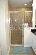 bathroom with a shower with door