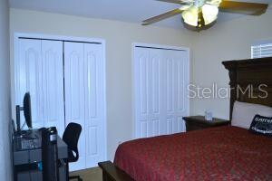 bedroom featuring two closets and ceiling fan