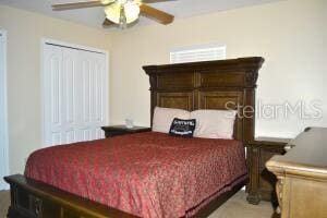 bedroom featuring ceiling fan and a closet