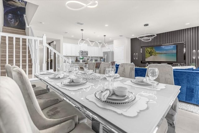 dining area with recessed lighting, visible vents, a notable chandelier, and stairway