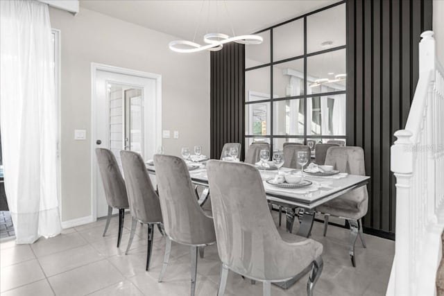 dining room featuring baseboards, an inviting chandelier, and tile patterned floors