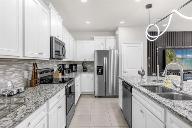 kitchen featuring sink, appliances with stainless steel finishes, backsplash, and white cabinetry