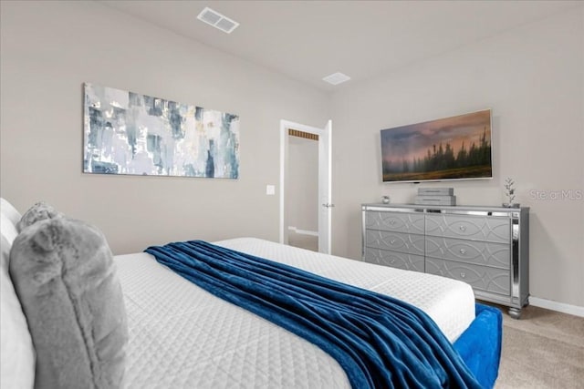 carpeted bedroom with visible vents and baseboards